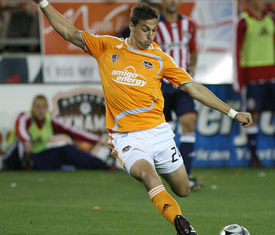HOUSTON - MAY 03: Geoff Cameron #20 of the Houston Dynamo shoots while Paulo Nagamura #5 of Chivas USA tries to block the shot on May 3, 2008 at Robertson Stadium in Houston, Texas. (Photo by Thomas B. Shea/MLS via Getty Images)