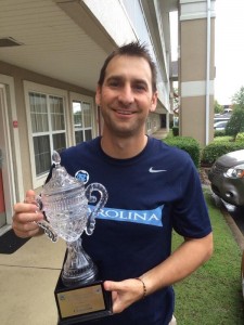 Jason Sisneros lifts the Region III Open Cup trophy