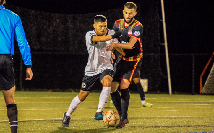 Wilber Gomez of Oyster Bay United (left) battles for the ball against a player from Westchester United in the final round of qualifying for the 2022 US Open Cup. Photo: Karla Esqueche | E&M Photography