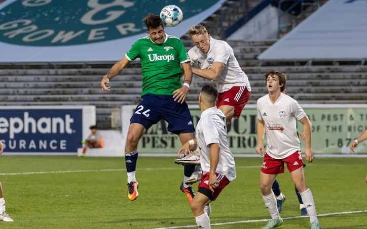 Players from the Richmond Kickers (green) and North Carolina Fusion U-23s go up for a header in the Third Round of the 2022 US Open Cup. Photo: Jessica Stone Hendricks Photography
