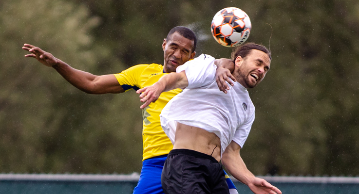Johnatan Mosquera (2) of El Farolito and Matt Fondy (11) of Inter SF fight for a header during a US Open Cup first round match at Ohlone College in Fremont, Calif. on Mar. 22, 2023. Photo: Douglas Zimmerman | SoccerBayArea
