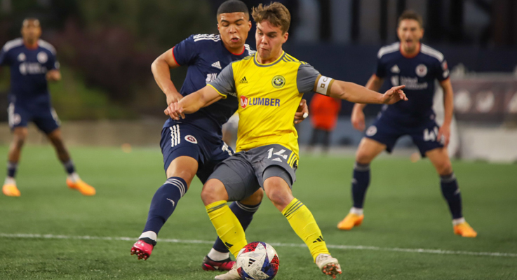 Robbie Mertz of the Pittsburgh Riverhounds battles for the ball against the New England Revolution in the 2023 US Open Cup. Photo: Pittsburgh Riverhounds SC