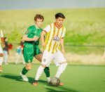 Players from Azteca FC (yellow) and Timbers SC (green) play for the ball in a 2024 USASA Region IV Amateur Cup Quarterfinal match (Credit: Azteca FC)