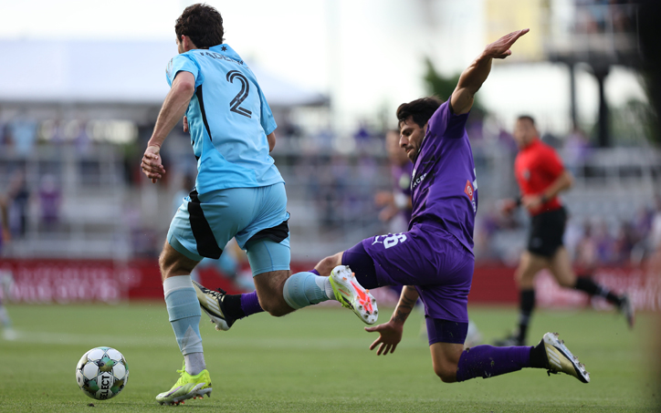Devin Padelford of Minnesota United (left) avoids a tackle from Louisville City FC in the Fourth Round of the 2025 US Open Cup. Photo: EM Dash Photography